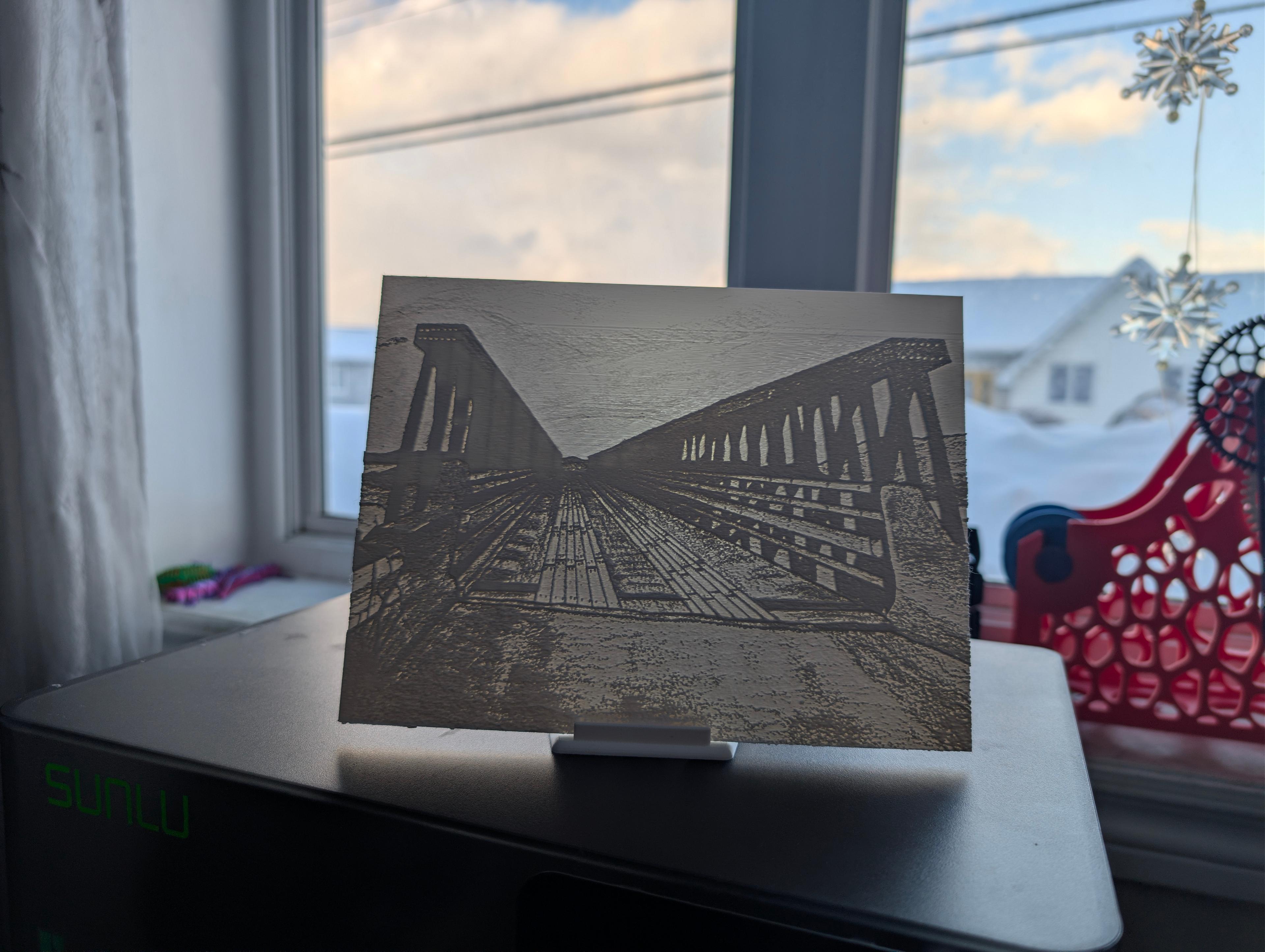 Gut Bridge lithophane displayed on a stand in front of a window